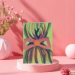 Vibrant celebration greeting card with an abstract design of a figure formed by energetic pink, magenta, and deep green brushstrokes, suggesting a dancer or joyful figure. The card, ideal for celebrations, is displayed in a bright pink studio setting.