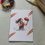 female footy card with ball in bright red colour