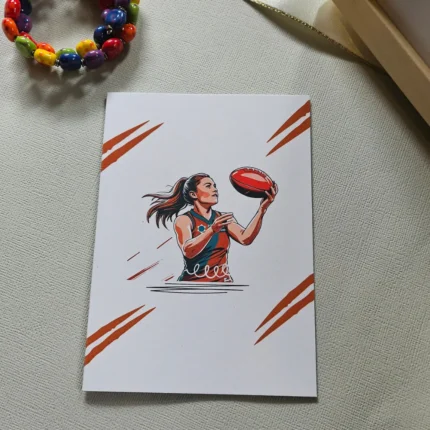 female footy card with ball in bright red colour