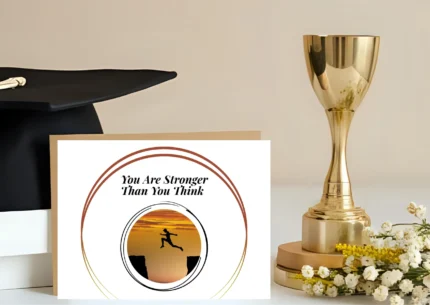 Affirmation card featuring the phrase 'You Are Stronger Than You Think' above a circular silhouette image of a person mid-leap over a cliff chasm against a sunset sky. A motivational card for strength and support.