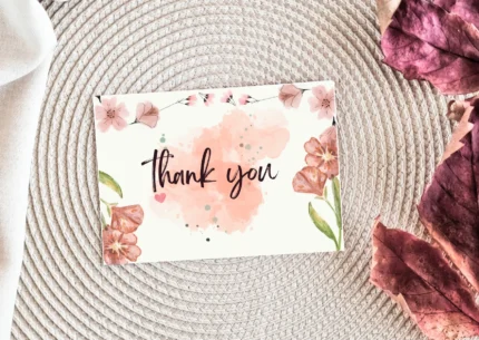 A vibrant thank you botanical card lay on table