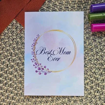 Best Mom Ever eco-friendly greeting card featuring a delicate gold circle and purple watercolor botanical details on a pastel background.