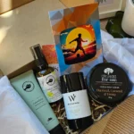 Open Organic Men's Grooming Gift Box showing hand cream, sleep mist, lemon myrtle soap, hemp body scrub, and a soccer sunset greeting card.