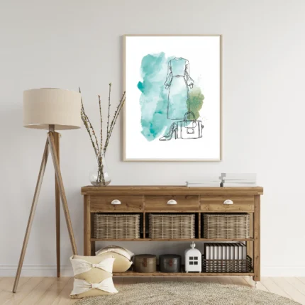 Close-up of watercolor wall art showing a teal dress, handbag, and high heel shoe sketches.