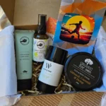 Kraft gift box filled with premium natural men's skincare products nestled in eco-friendly brown paper shred packaging.