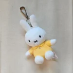 Close up of a handmade rabbit keychain showing the soft organic fabric and silver clasp.