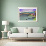 A large canvas print of the Yarra River Bridge Melbourne wall art styled elegantly above a modern grey sofa in a brightly lit living room.