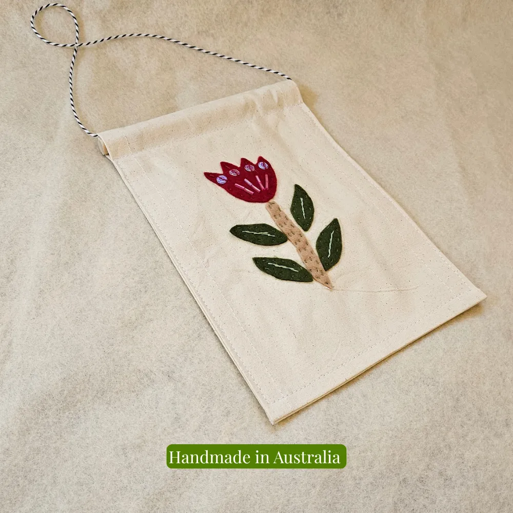 Handmade embroidered flower wall hanging Handmade embroidered flower wall hanging on natural fabric background