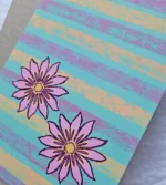 Colourful floral greeting card styled on a bedroom bedside table with soft neutral décor.
