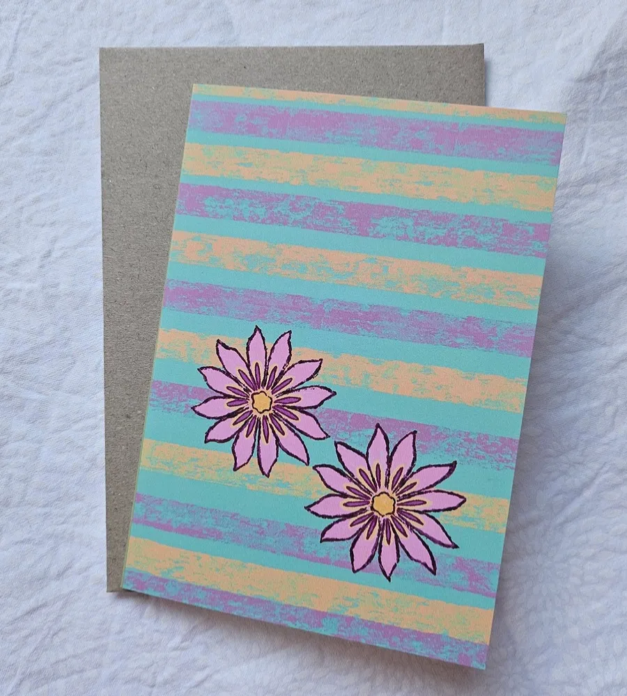 Handmade Floral Greeting Card Handmade floral greeting card featuring two pink flowers on a turquoise, lavender and peach striped background.