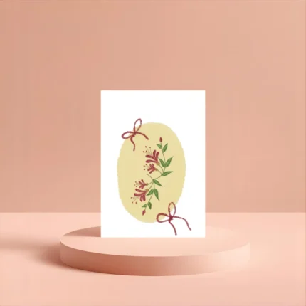 Greeting card with crimson honeysuckle and red bows on a yellow oval