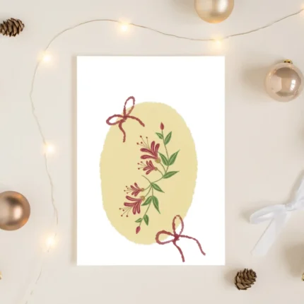 Honeysuckle and red bow greeting card styled with Christmas baubles and fairy lights