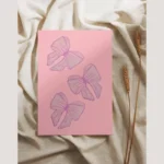 Pink greeting card with three hand-drawn lilac bows