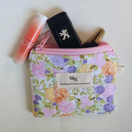 Pastel floral cotton fabric on a handmade zipper pouch